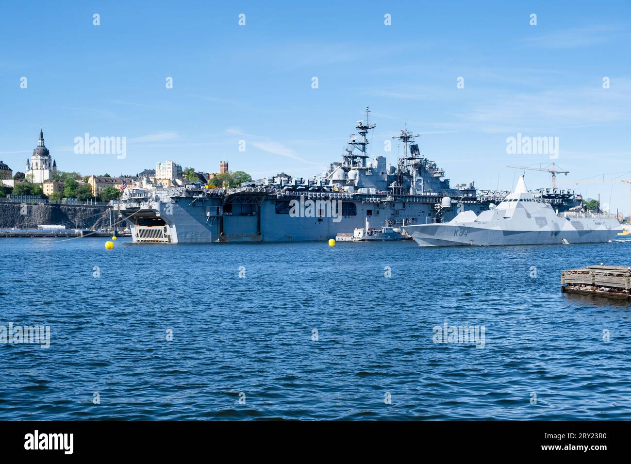 Swedish Navy ship HSwMS Nyköping (K34) Visby Class Corvette and American aircraft carrier USS Kearsarge, Stockholm Harbour, Sweden. Photo: Rob Watkins Stock Photo