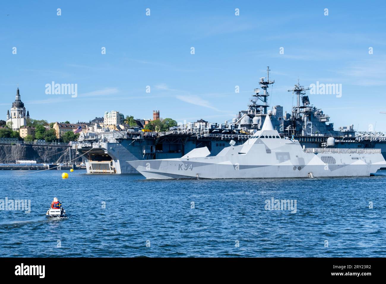 Swedish Navy ship HSwMS Nyköping (K34) Visby Class Corvette and American aircraft carrier USS Kearsarge, Stockholm Harbour, Sweden. Photo: Rob Watkins Stock Photo