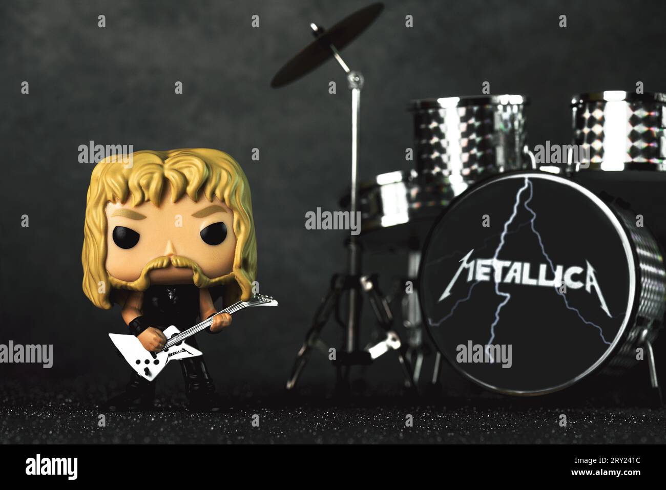 Funko POP vinyl figure of James hetfield singer of the american heavy metal group Metallica next to the battery against dark background. Illustrative Stock Photo