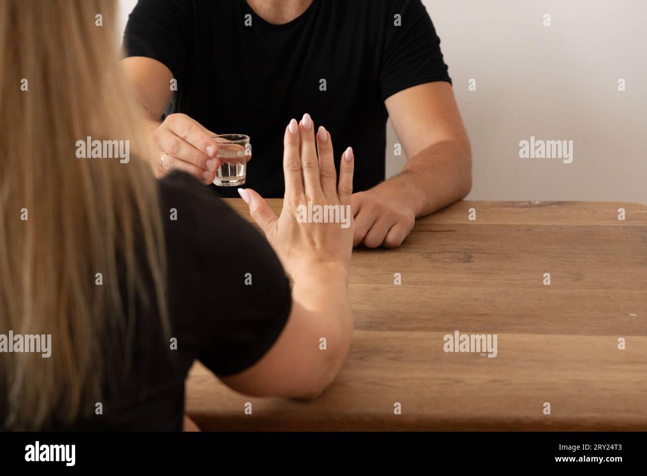 woman, refusing alcohol, not drinking vodka, alcohol-free New Year's Eve, NOLO, abstinence, tackling alcohol issues, saying no to drinks at social Stock Photo