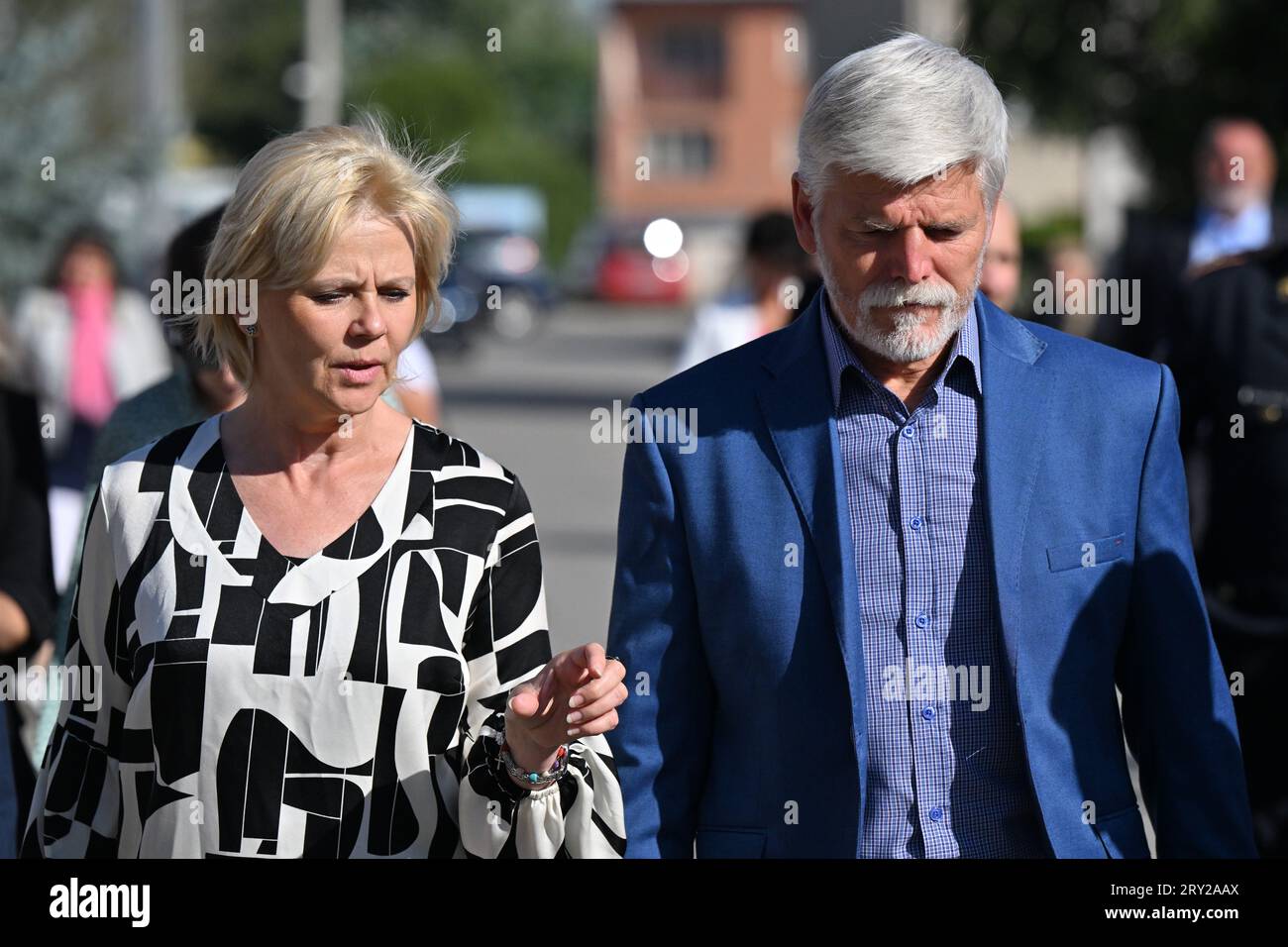 Czech President Petr Pavel (right) with his wife Eva Pavlova (centre) visit the village Hrusky