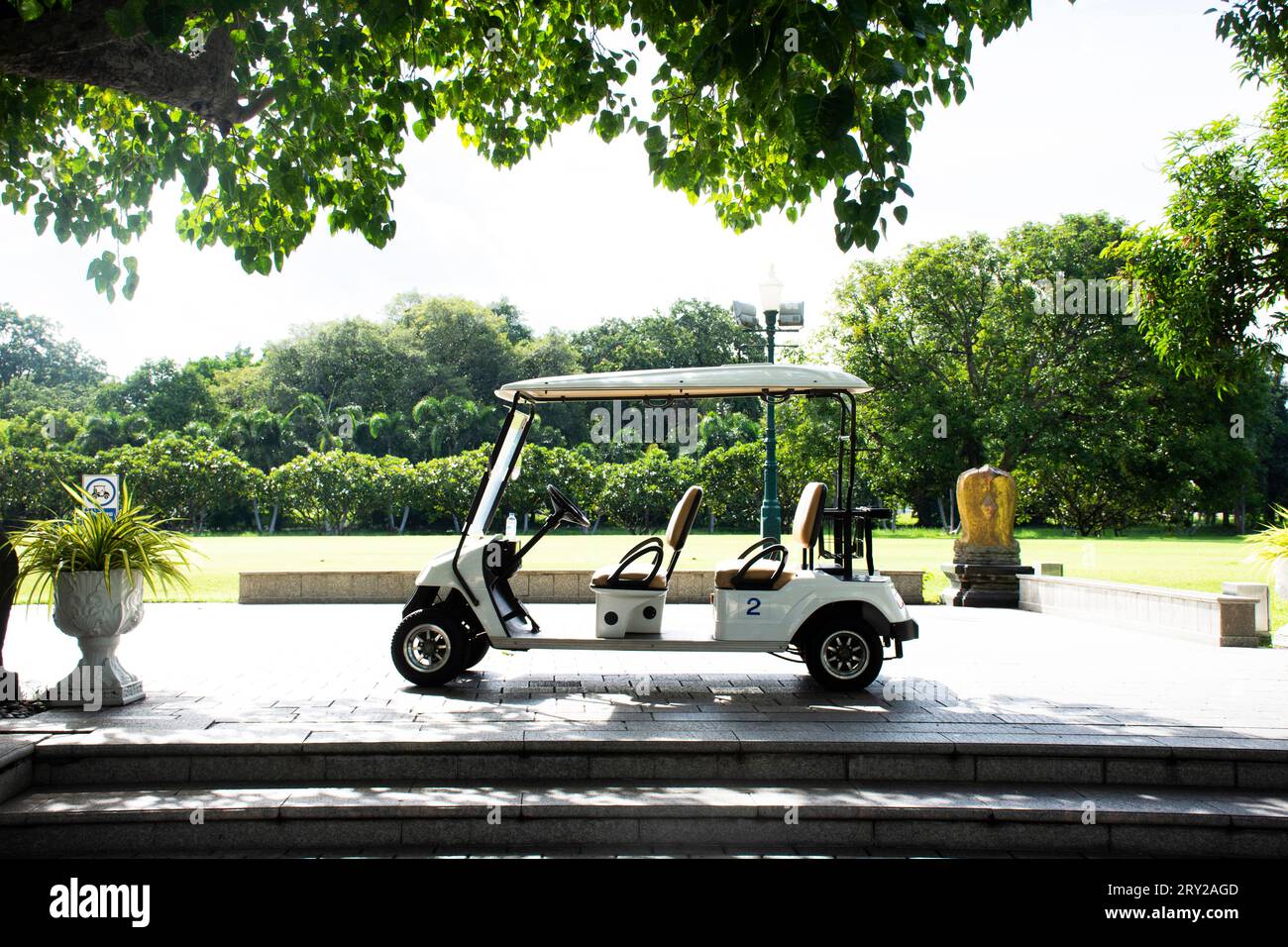 Golf carts electric car or electrical vehicle stop on street road in