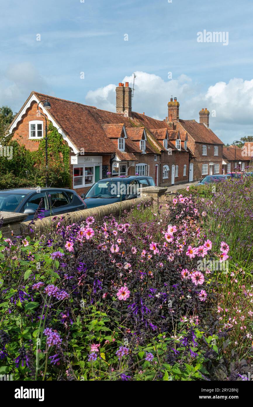 View of Beaulieu High Street from Fairweathers Garden Centre with flowers in the foreground, New Forest, Hampshire, England, UK Stock Photo