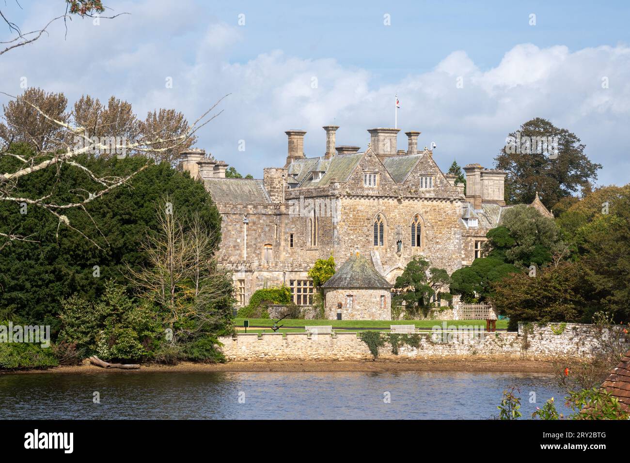 View of Beaulieu Palace House across Beaulieu River from the village, New Forest, Hampshire, England, UK Stock Photo