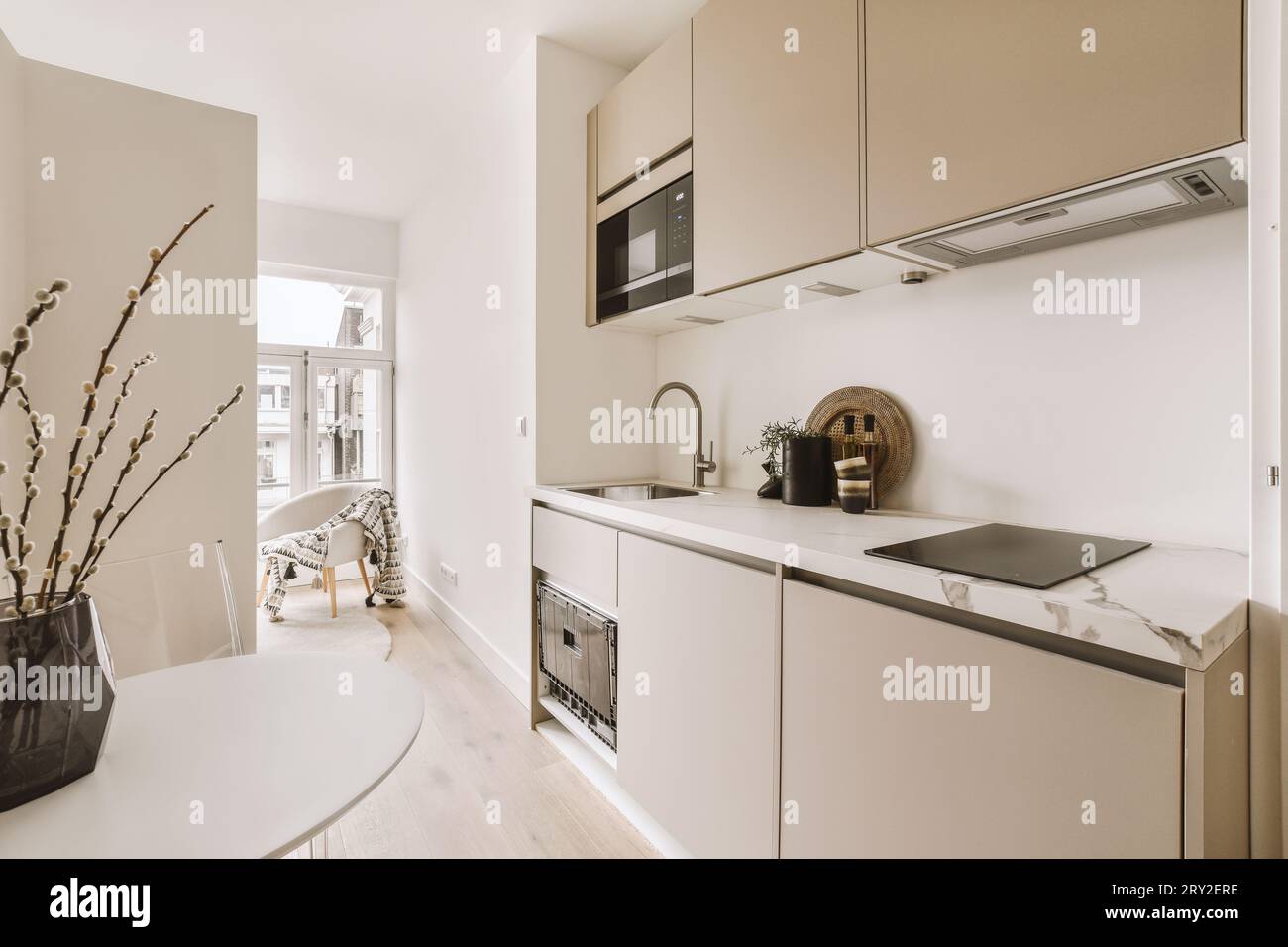 Interior of stylish kitchen with white cabinet and built in appliances ...