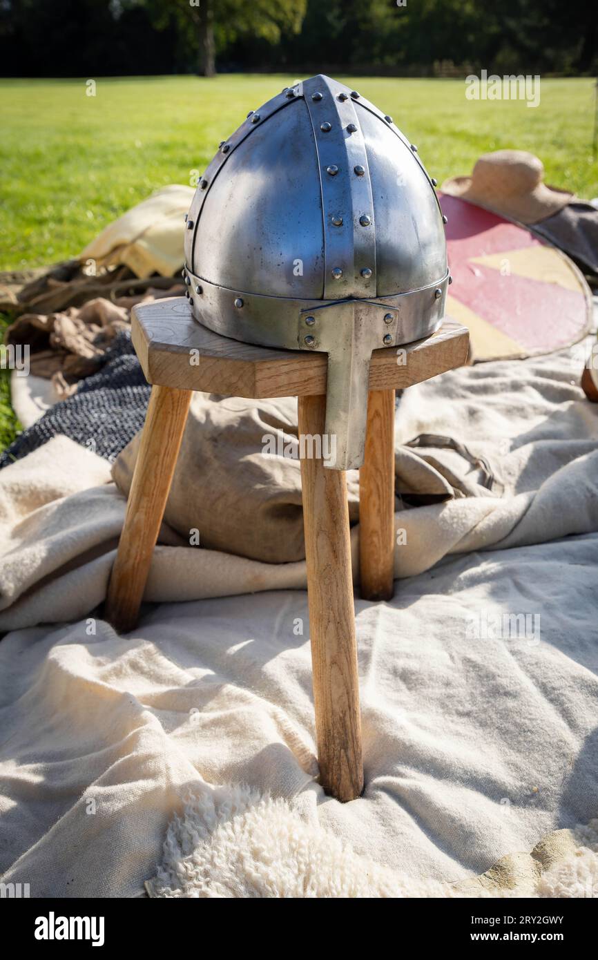 Viking invaders build a village to celebrate 1100 years of the ancient “cyty” of Thelwall. Viking head protection resting on a three-legged wooden sto Stock Photo