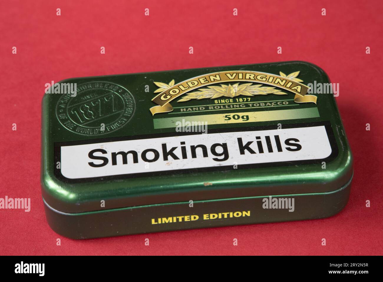 Green 50g tin of Limited Edition Golden Virginia hand rolling tobacco  with larger letters Smoking Kills UK Stock Photo