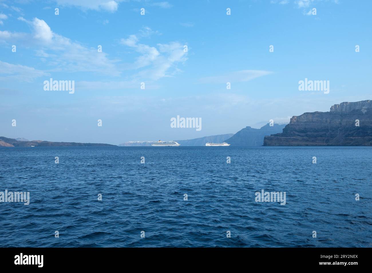 Santorini, Greece - September 7, 2023 : View of three large cruise liners next to the breathtaking volcanic landscape of Santorini Stock Photo