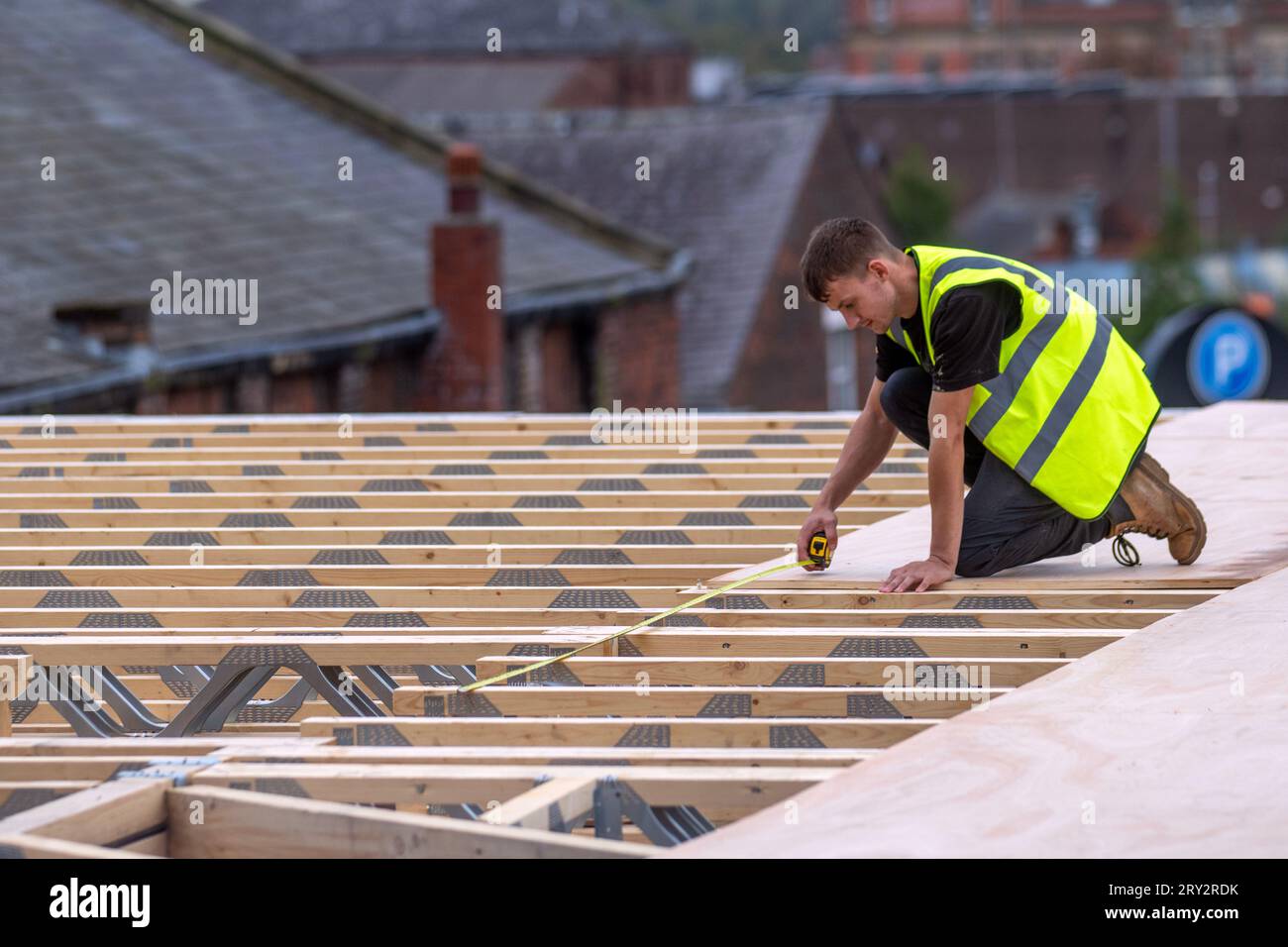 Extraordinary timber roof extension underway on city centre building in Preston. The elevation uses waterproof SterlingOSB Zero timbers and lattice roof trusses to support. Stock Photo