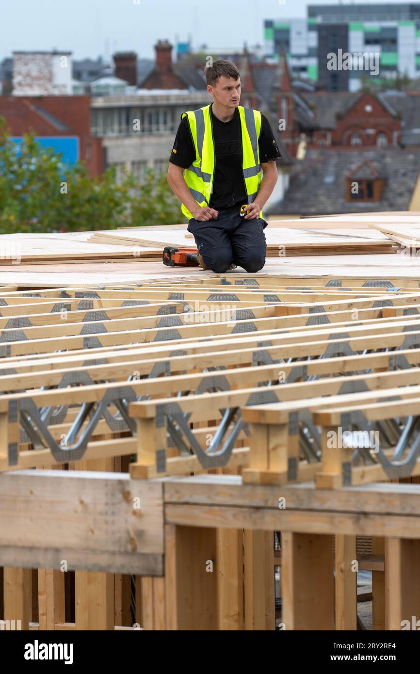 Extraordinary timber roof extension underway on city centre building in Preston. The elevation uses waterproof SterlingOSB Zero timbers and lattice roof trusses to support. Stock Photo