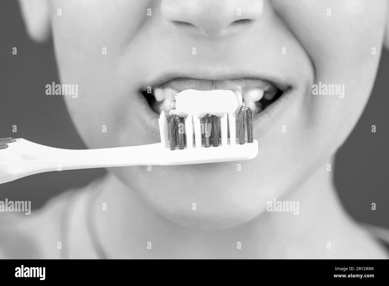 Boy toothbrush white toothpaste. Dental hygiene. Happy little kid brushing her teeth. Kid boy brushing teeth. Black and white Stock Photo
