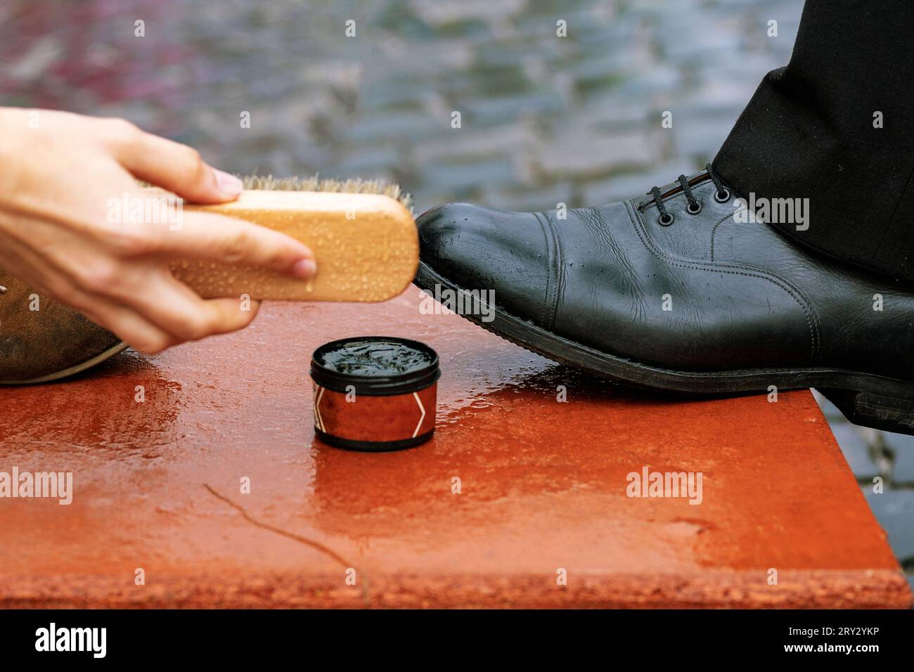 Shoe cream, brush closeup. Cleaning of boots on the street. Concept