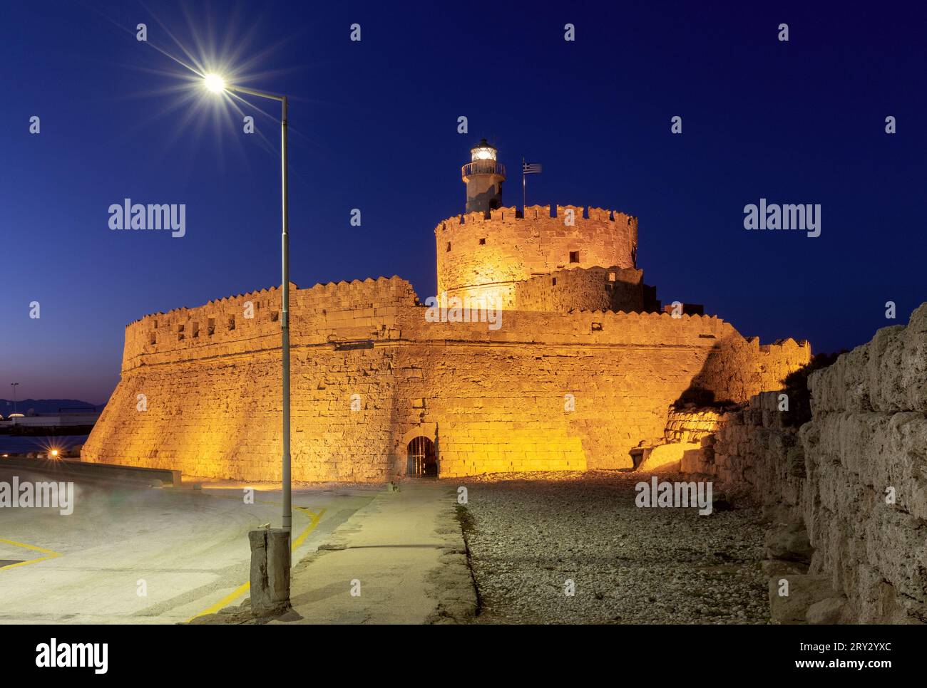 View of the old medieval stone lighthouse Fort St. Nicholas in Rhodes ...