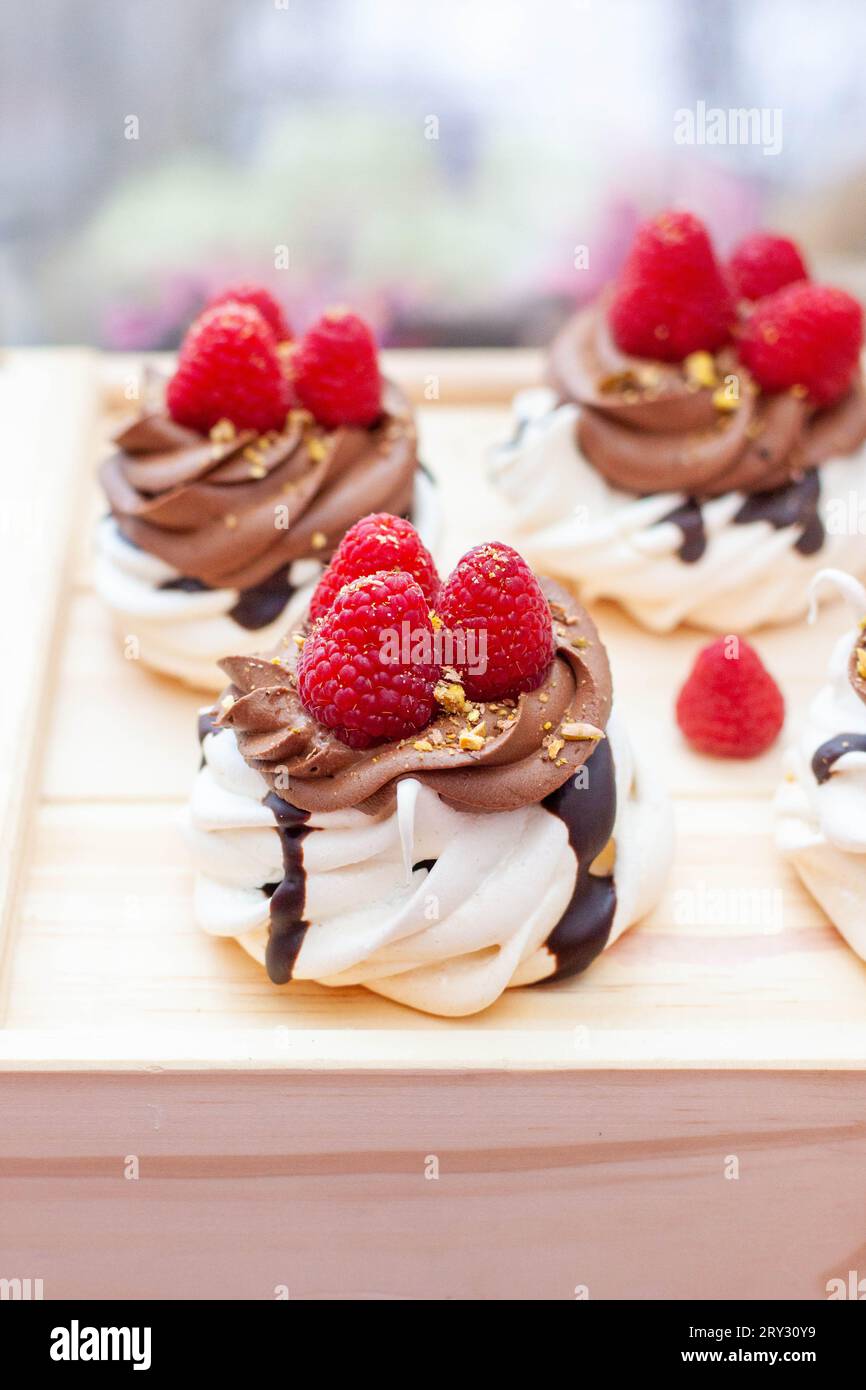 Mini cakes with whipped cream, chocolate, meringue and fresh ...