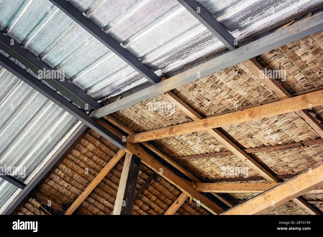 Ceiling covered with insulation combined with thatched roof. Aluminum