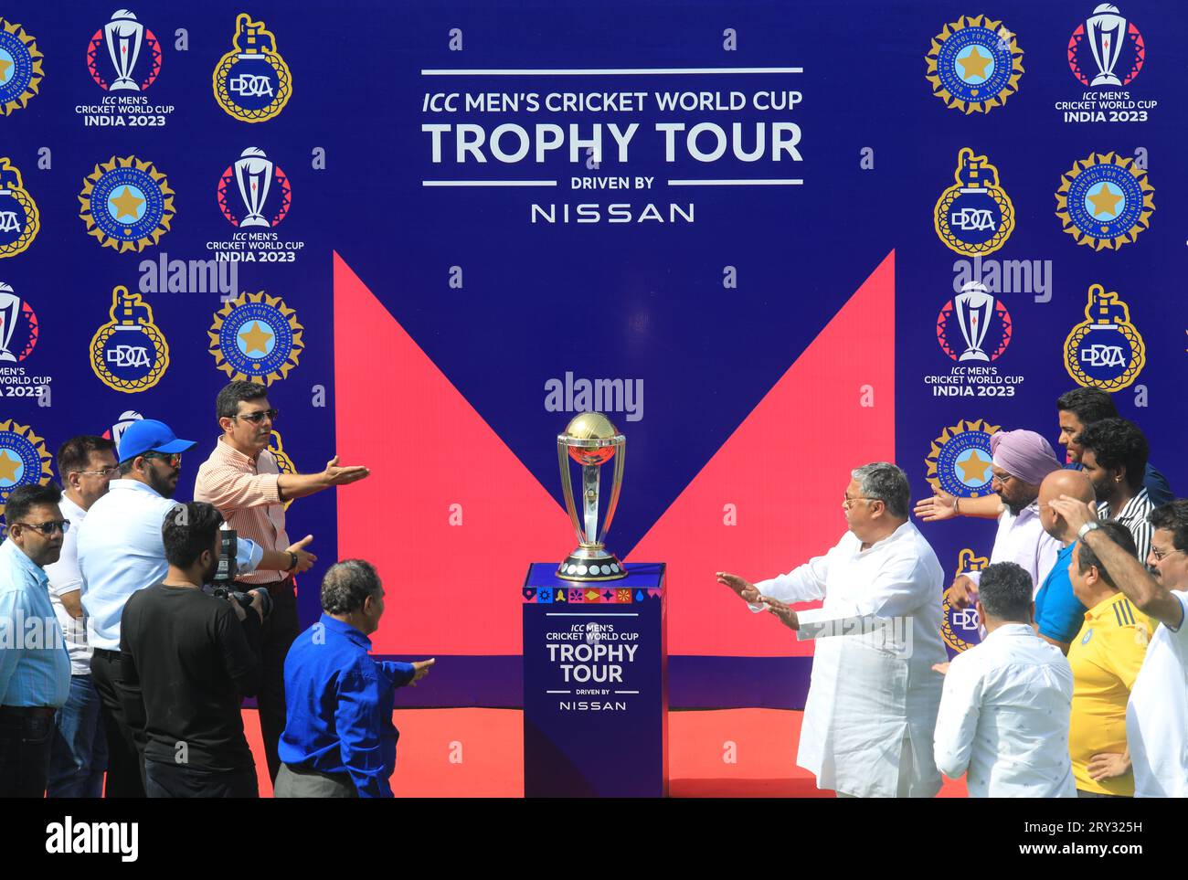 New Delhi, India. 28th Sep, 2023. Officials seen pointing at the ICC World Cup 2023 trophy during its tour, at the Arun Jaitley Stadium. The 2023 ICC Men's Cricket World Cup start from 5th October-19th November-2023. Ten national Cricket team will participate and the tournament will take place in ten different stadium in India. Credit: SOPA Images Limited/Alamy Live News Stock Photo