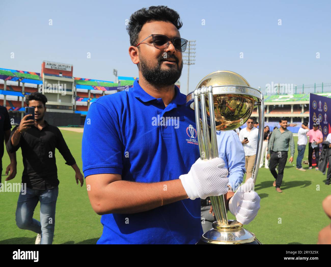 New Delhi, India. 28th Sep, 2023. An official seen holding the ICC World Cup 2023 trophy, during its tour, at the Arun Jaitley Stadium. The 2023 ICC Men's Cricket World Cup start from 5th October-19th November-2023. Ten national Cricket team will participate and the tournament will take place in ten different stadium in India. Credit: SOPA Images Limited/Alamy Live News Stock Photo