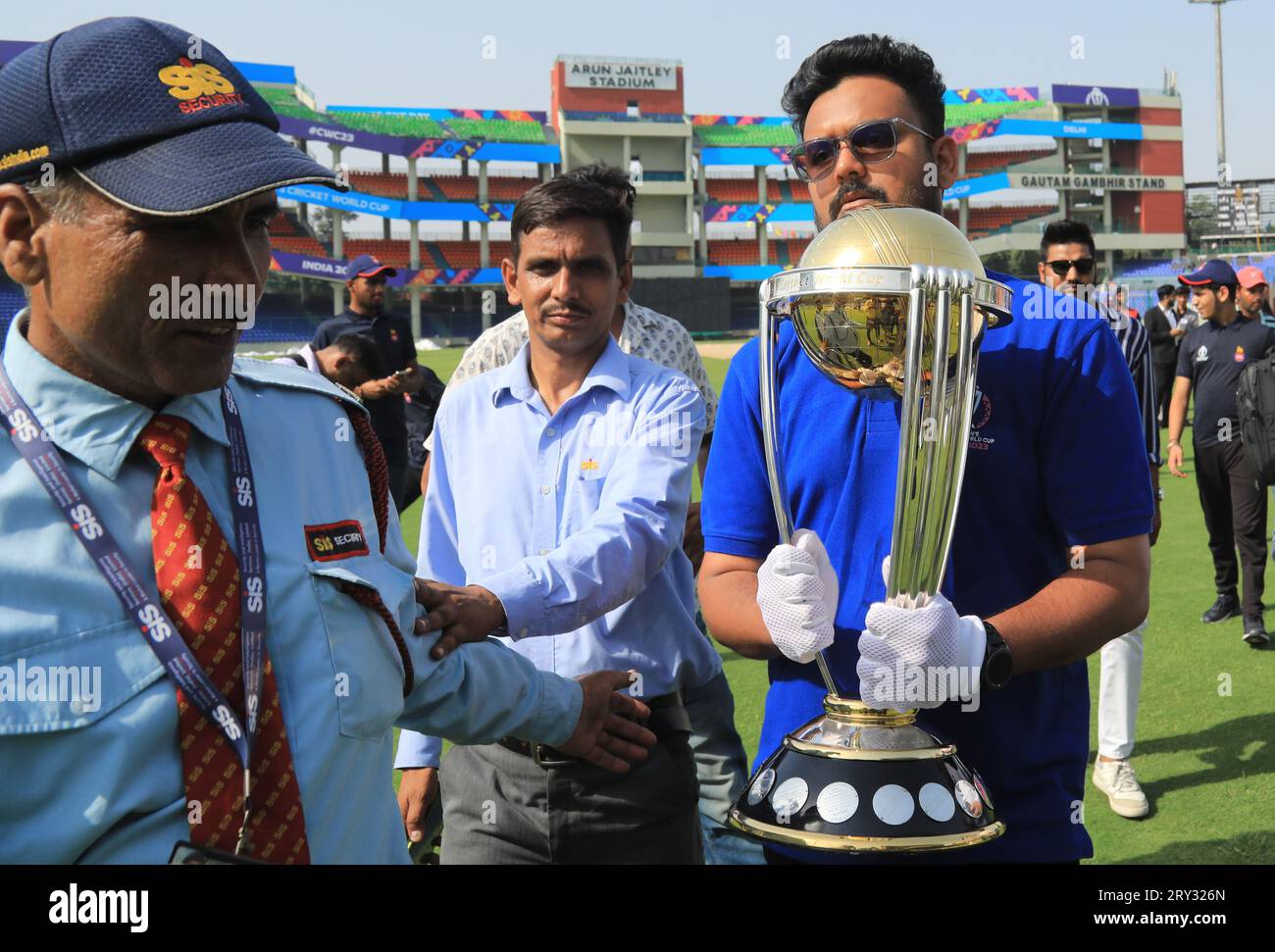 New Delhi, India. 28th Sep, 2023. An official seen holding the ICC World Cup 2023 trophy, during its tour, at the Arun Jaitley Stadium. The 2023 ICC Men's Cricket World Cup start from 5th October-19th November-2023. Ten national Cricket team will participate and the tournament will take place in ten different stadium in India. Credit: SOPA Images Limited/Alamy Live News Stock Photo