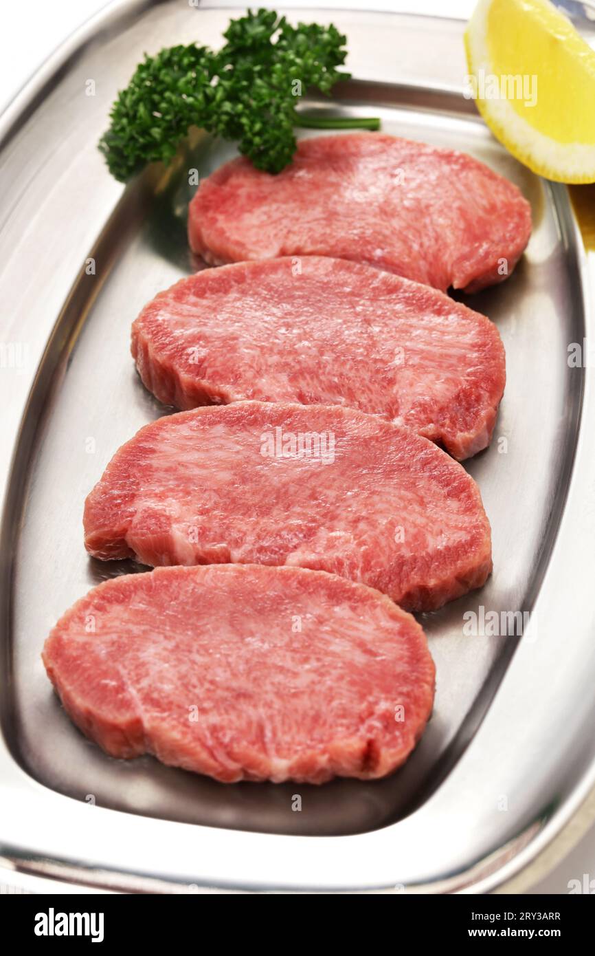 sliced beef tongue. Beef tongue is one of the popular ingredients for Yakiniku (Japanese-style barbecue). Stock Photo