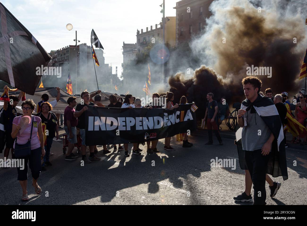 Barcelona, Catalonia, Spain - September 11, 2023: Group of radical independentists burn a black smoke bomb during the National Day of Catalonia demons Stock Photo