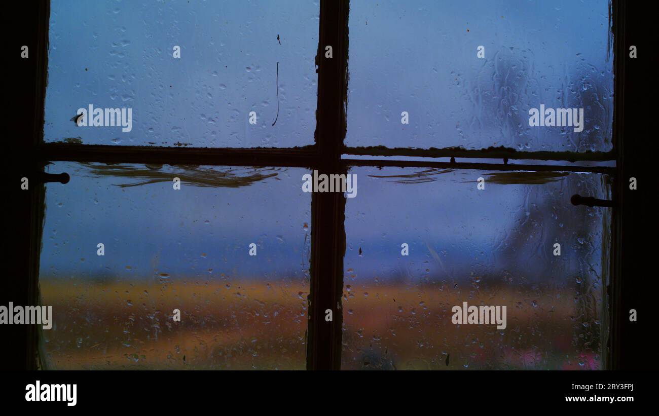 Desolate Window Lonesome fly scales a rain dappled window pane that offers a desolate ...