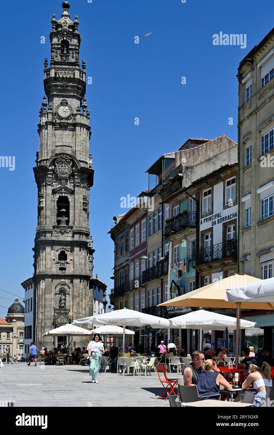 Historic landmark, 76m-high baroque bell tower Torre dos Clérigos with public square and sidewalk eating out in front, Porto, Portugal Stock Photo