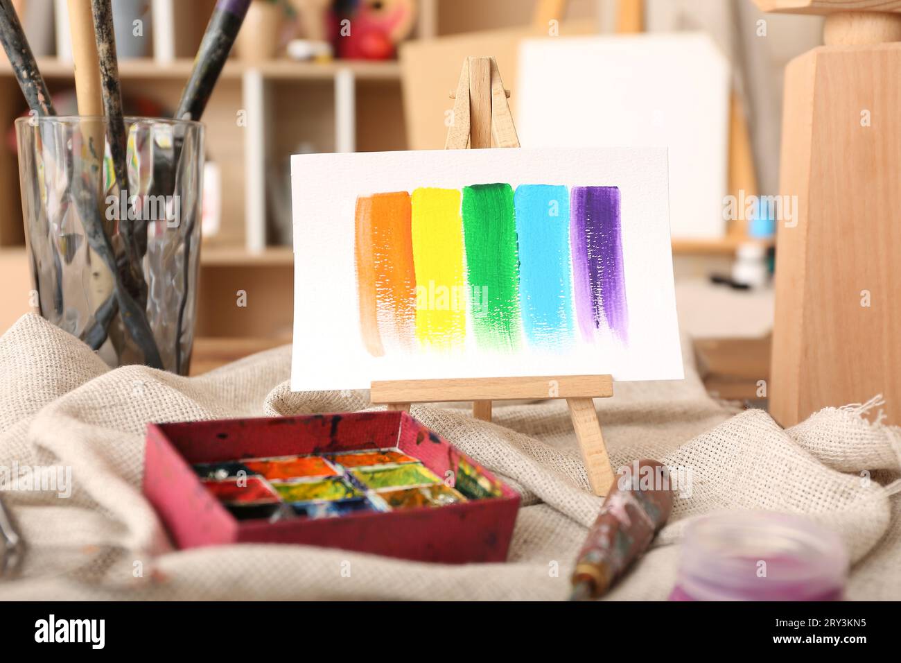 Mini easel with paints strokes in artist's studio Stock Photo
