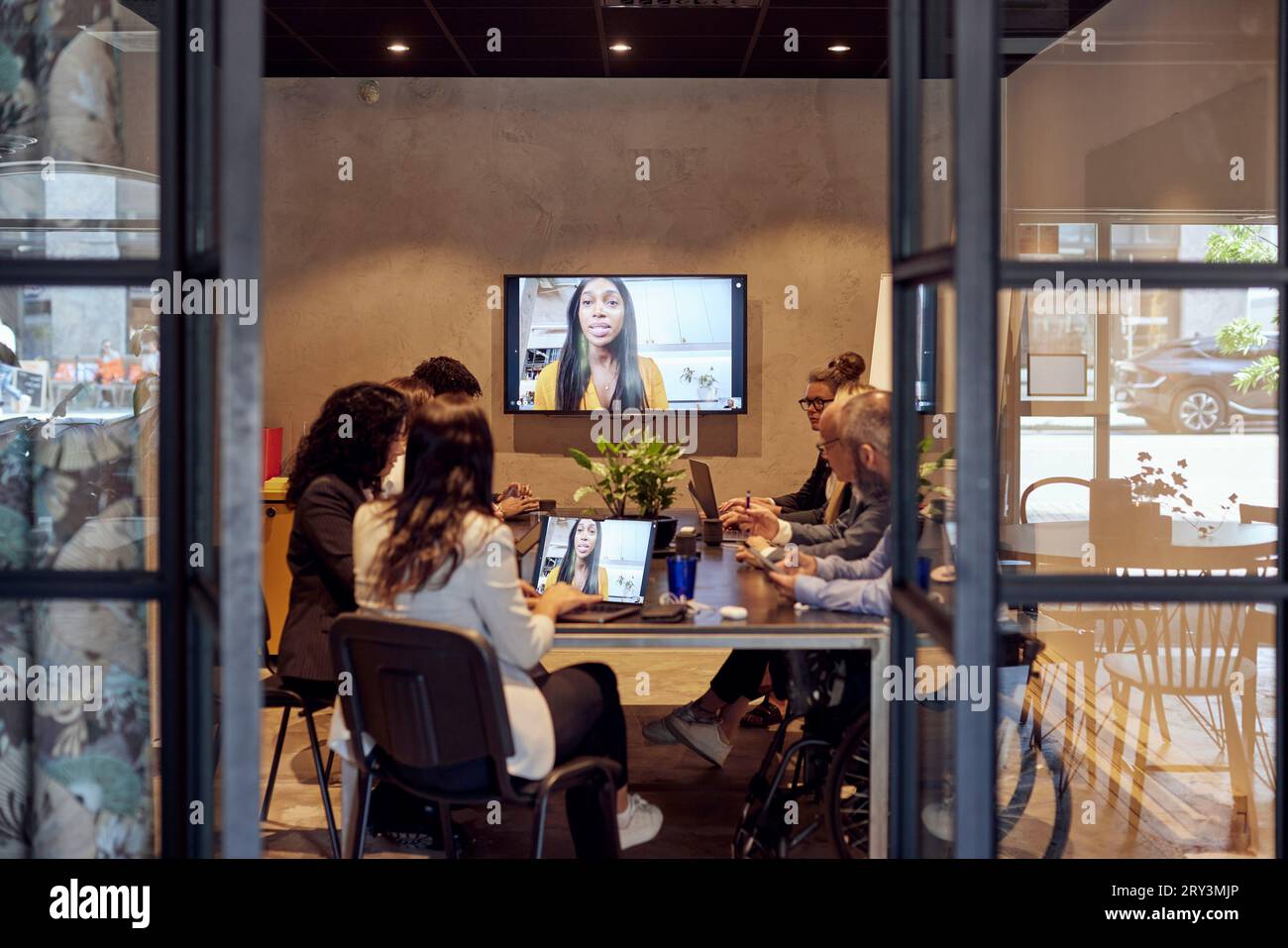 Multiracial business team discussing through virtual meeting at creative office Stock Photo