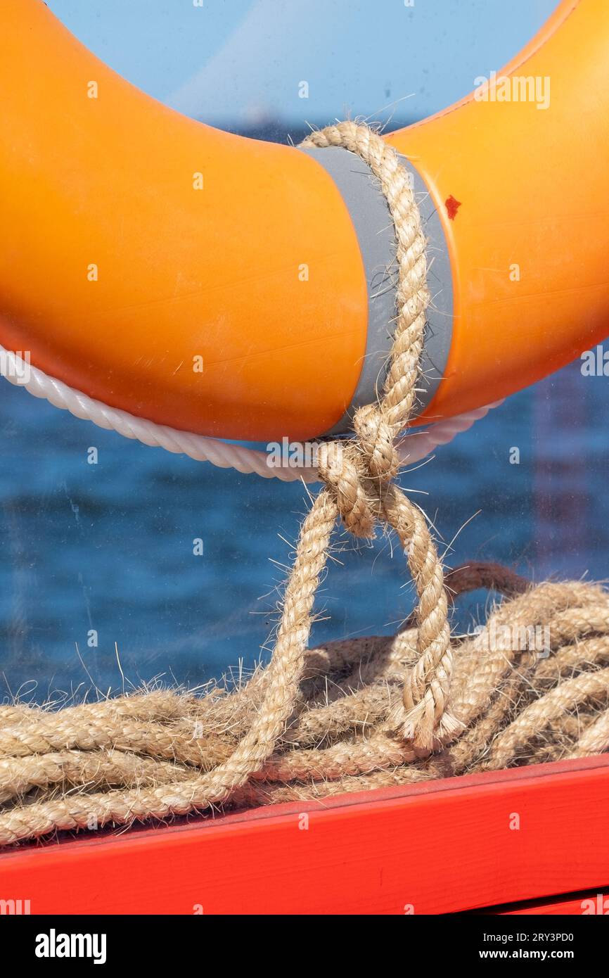 Lifebuoy Rope A lifebuoy is attached to a bright orange wooden frame with linen ropes ...