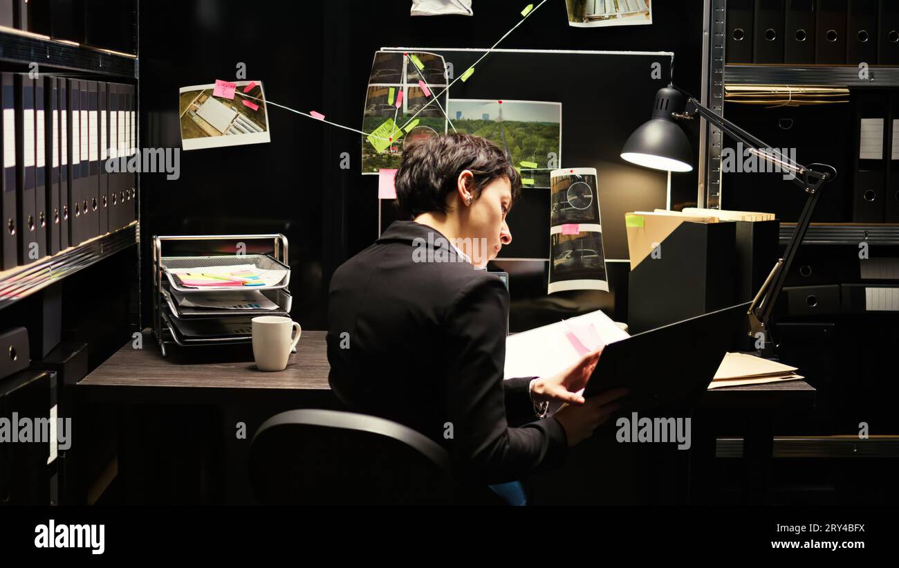 Detective reads valuable information in classified file documents