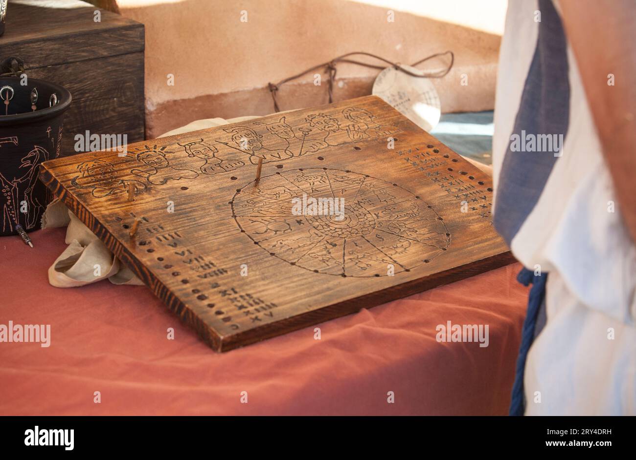 Reenactor reading annual roman calendar and zodiac. Divination methods in ancient rome Stock Photo