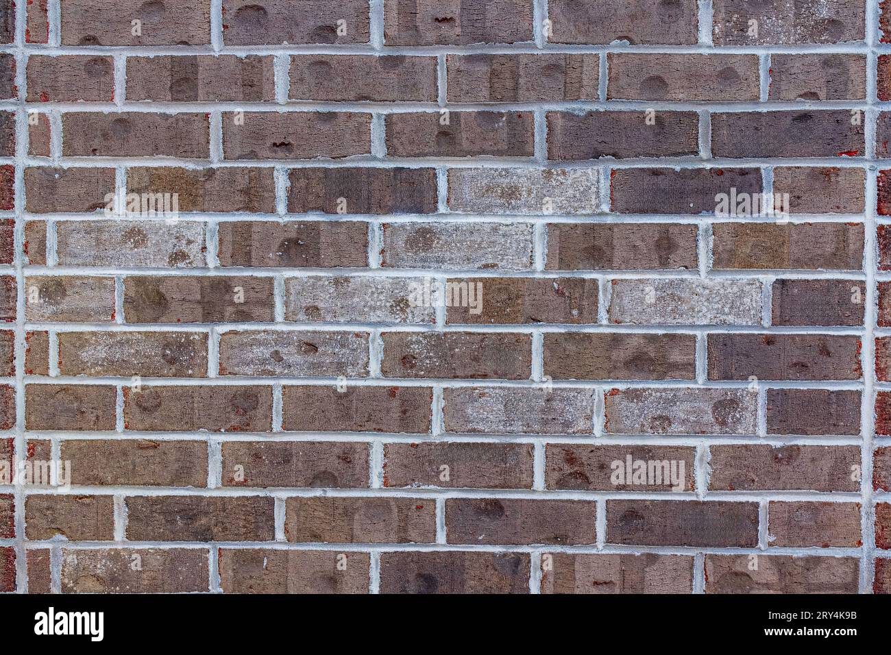 Brown brick wall texture with white mortar joints, architectural background. Stock Photo