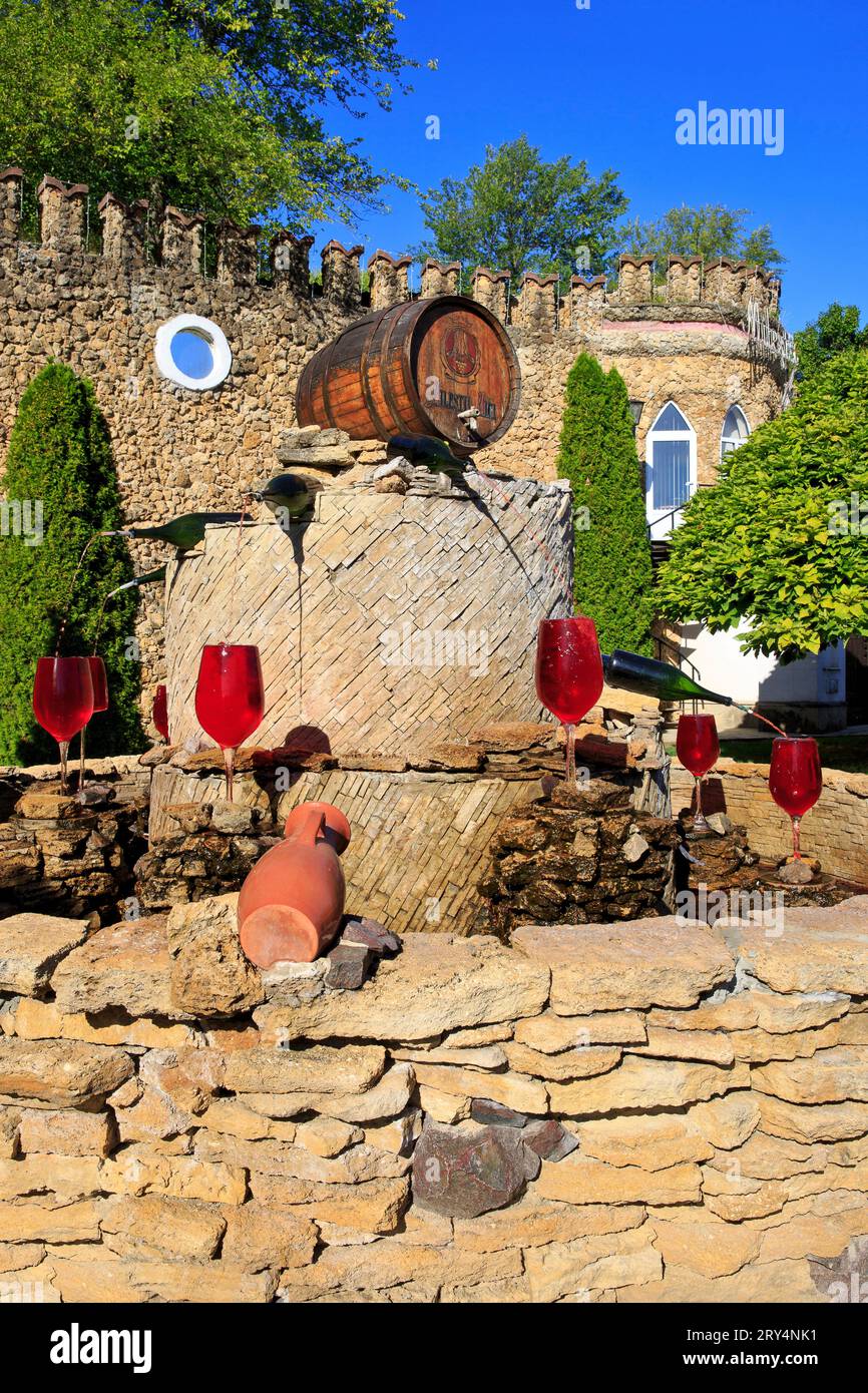 Wine bottles pourring red wine in wine glases at the wine fountain of