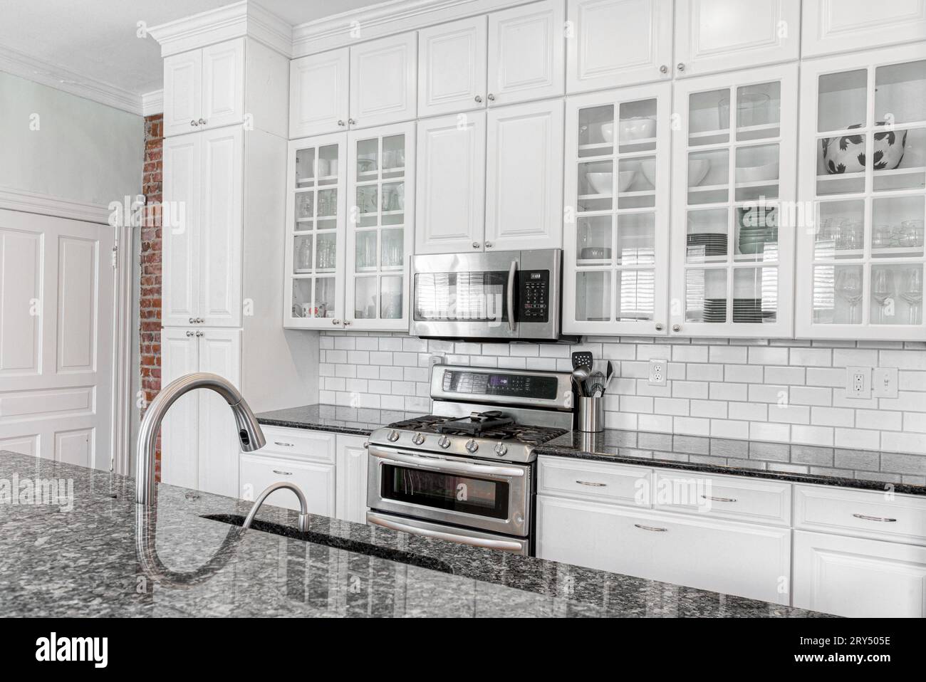 Modern White Kitchen Interior with Exposed Brick Wall and Subway Tile