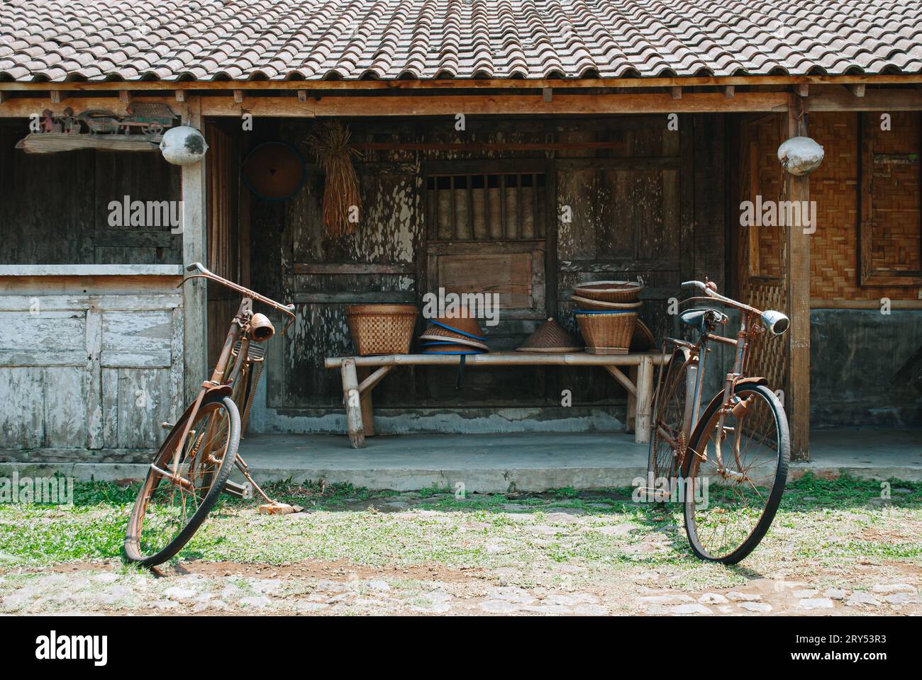 Traditional Javanese house known as Joglo with two worn bicycles in ...