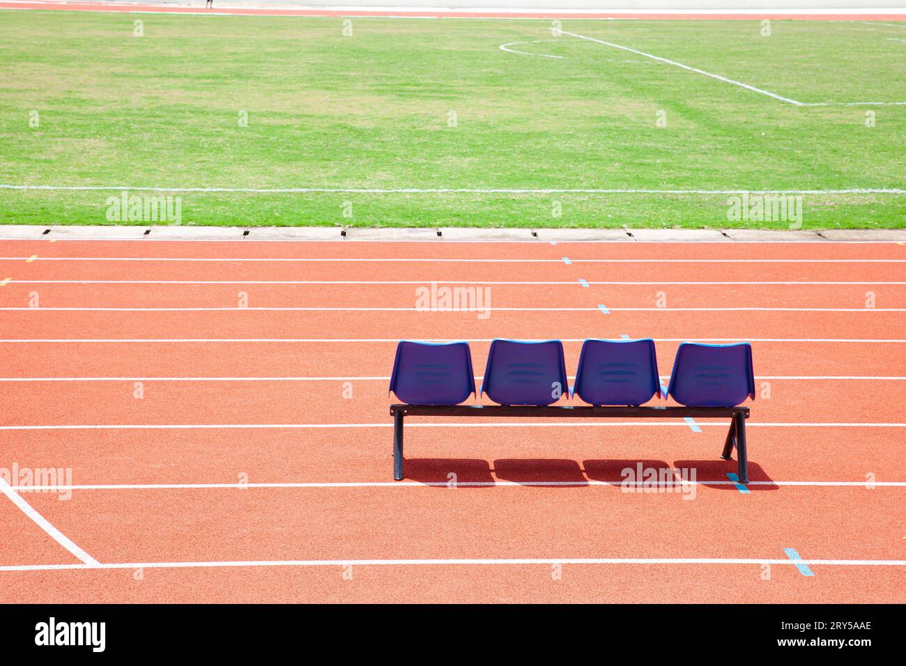 Blue reserve chair bench for staff, coach, substitutes players bench in outdoors sport stadium Stock Photo