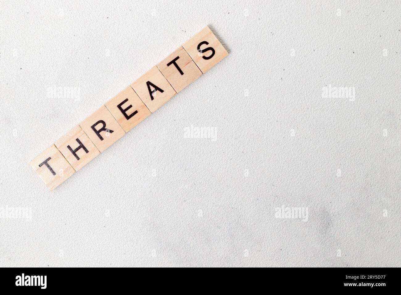 Top view of Threats word on wooden cube letter block on white background. Business concept Stock Photo