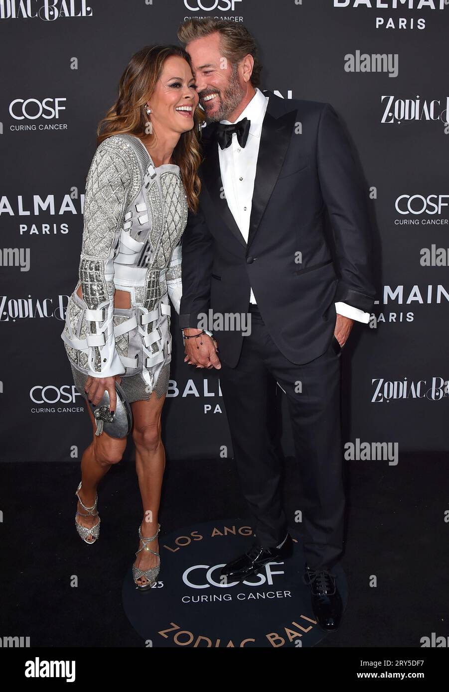 Brooke Burke, left, and Scott Rigsby arrive at the Zodiac Ball