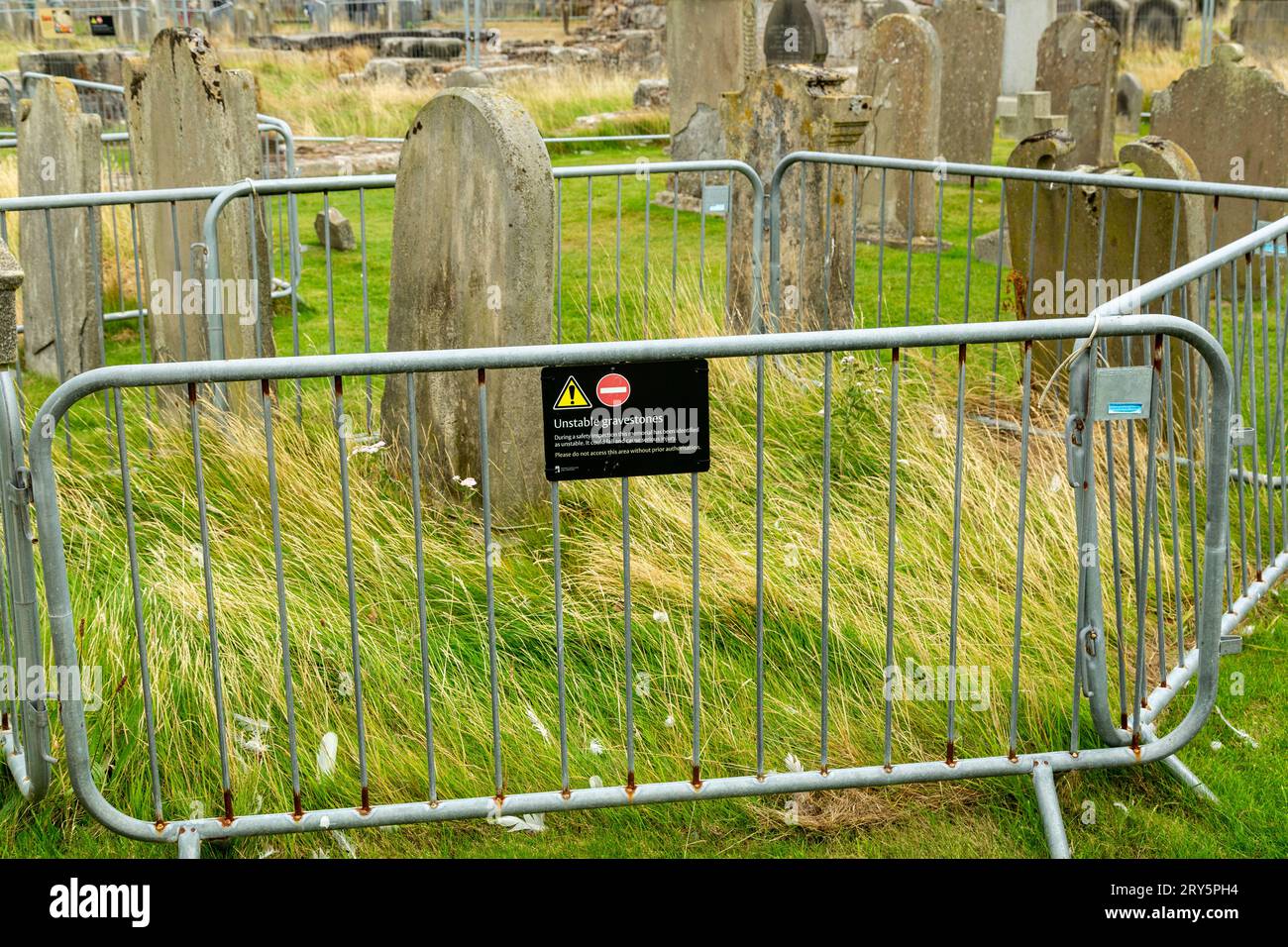 safety barriers around unstable headstones in St Andrews cemetery. Stock Photo