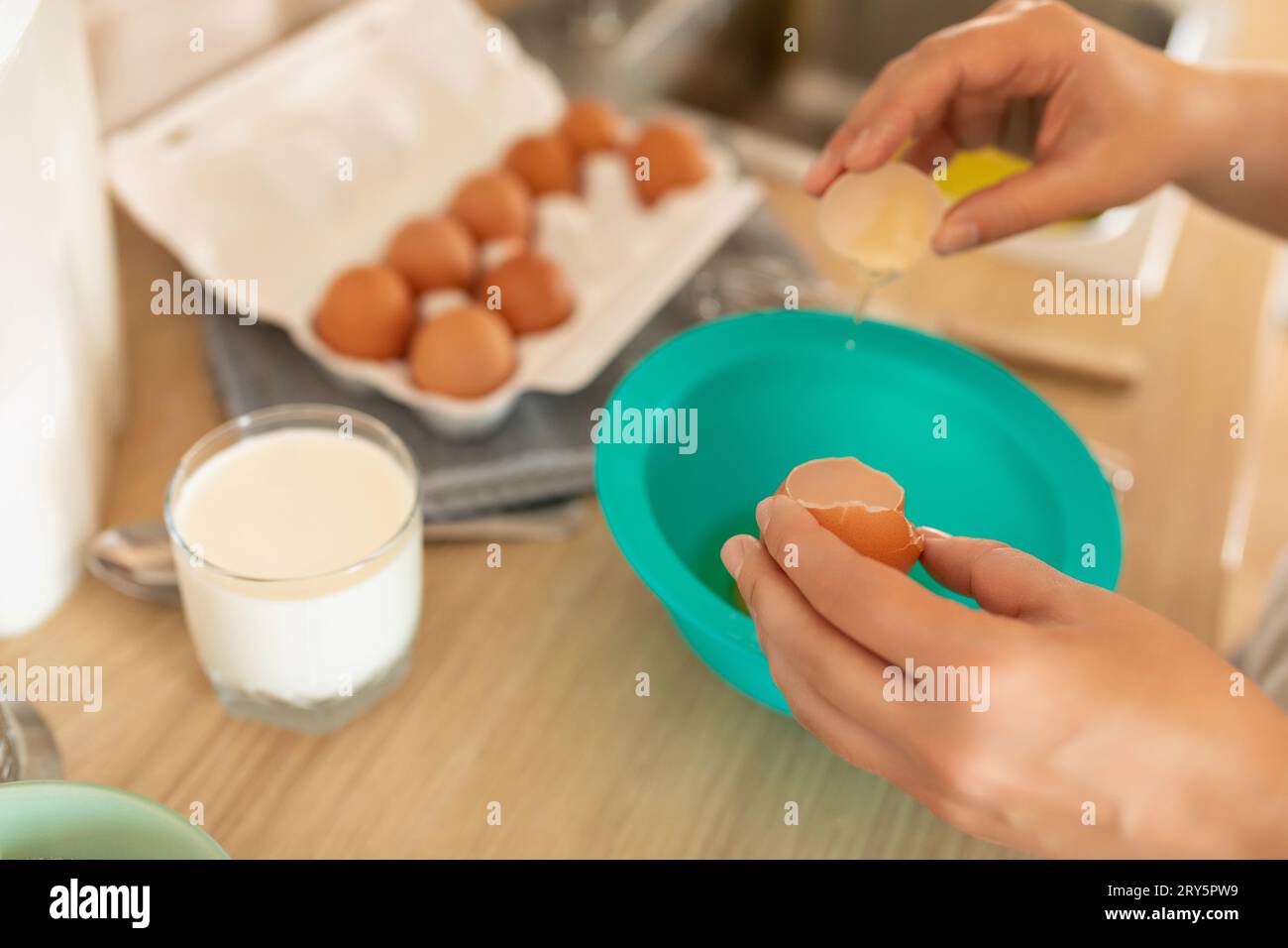 the process of breaking hen's eggs into a bowl, cracked shells Stock Photo Alamy