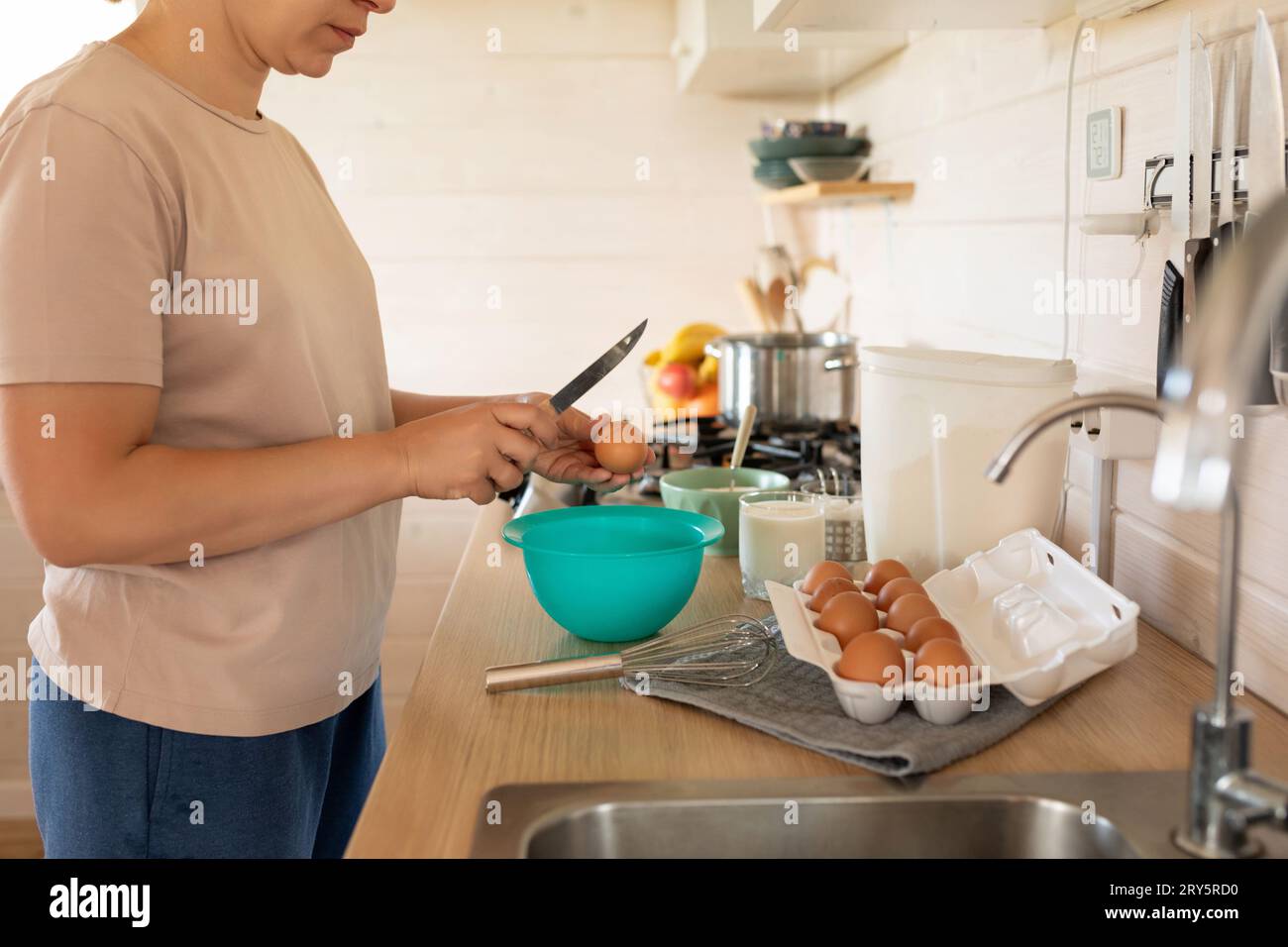 the process of breaking hen's eggs into a bowl, cracked shells Stock Photo Alamy