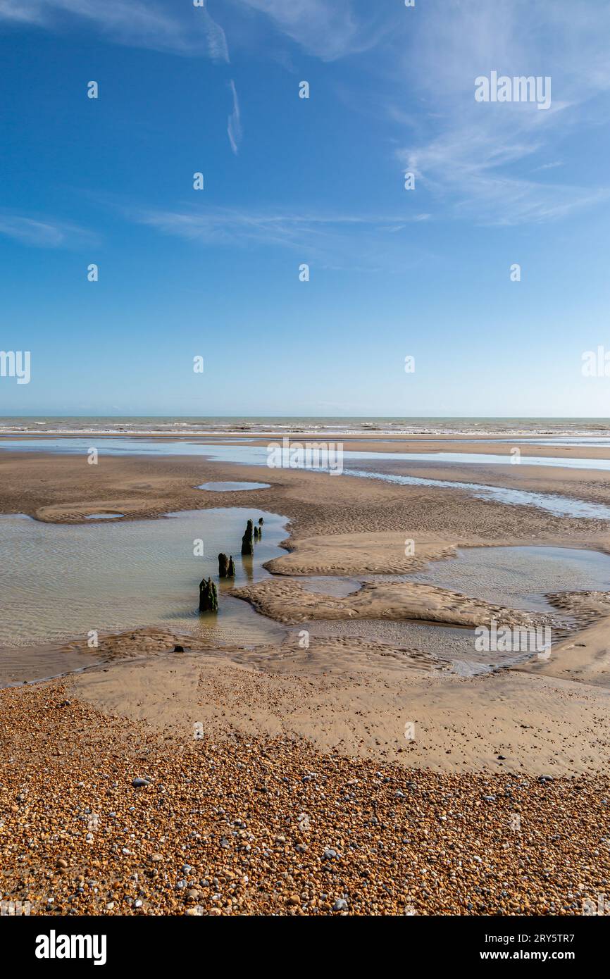 Low tide at Winchelsea beach on the Sussex coast, with a blue sky