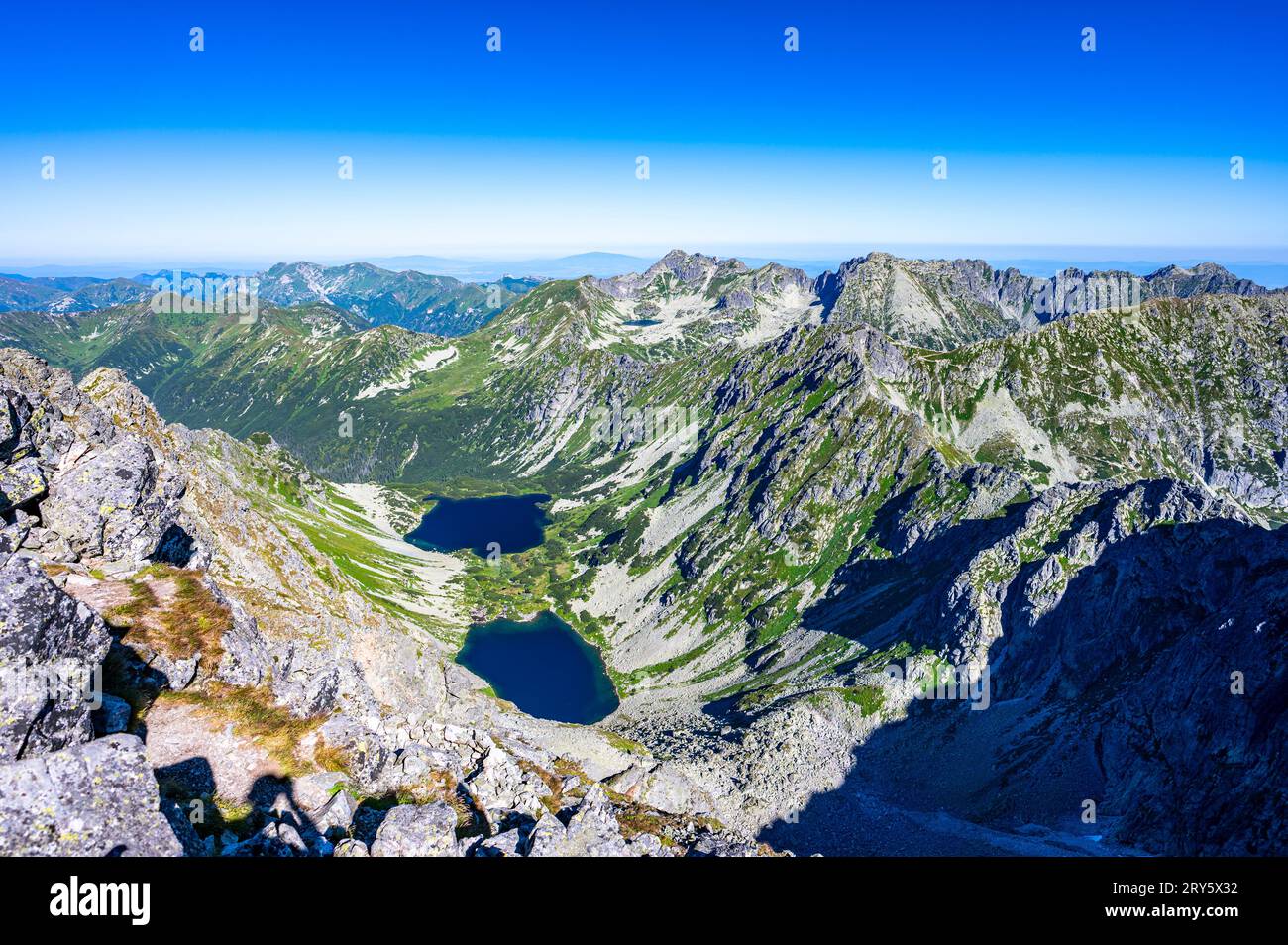 A view of the High Tatras with the Temnosmrecenske lakes from the Koprovsky Stit, Slovakia. Stock Photo