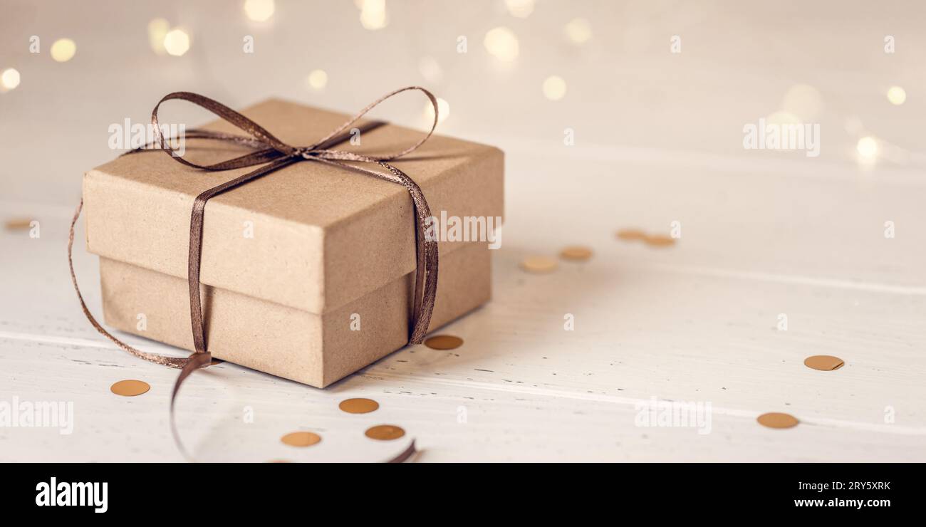 Christmas gift box on white wooden table. Front view. Stock Photo