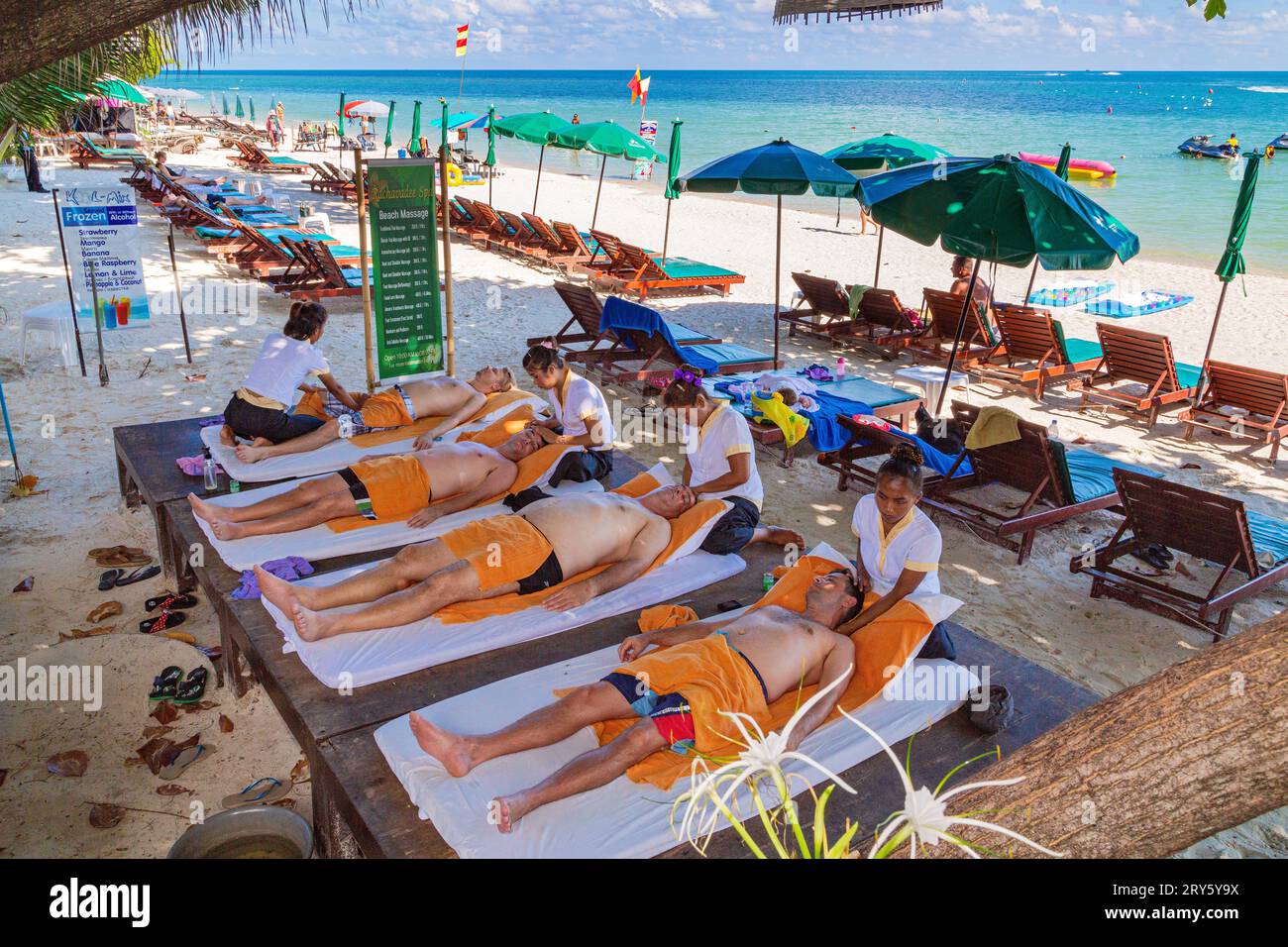 Ladies giving traditional Thai massage on Chaweng Beach, Ko Samui, Thailand Stock Photo