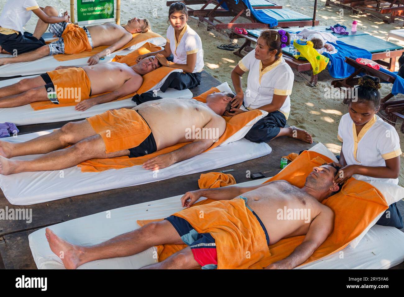 Ladies giving traditional Thai massage on Chaweng Beach, Ko Samui, Thailand Stock Photo