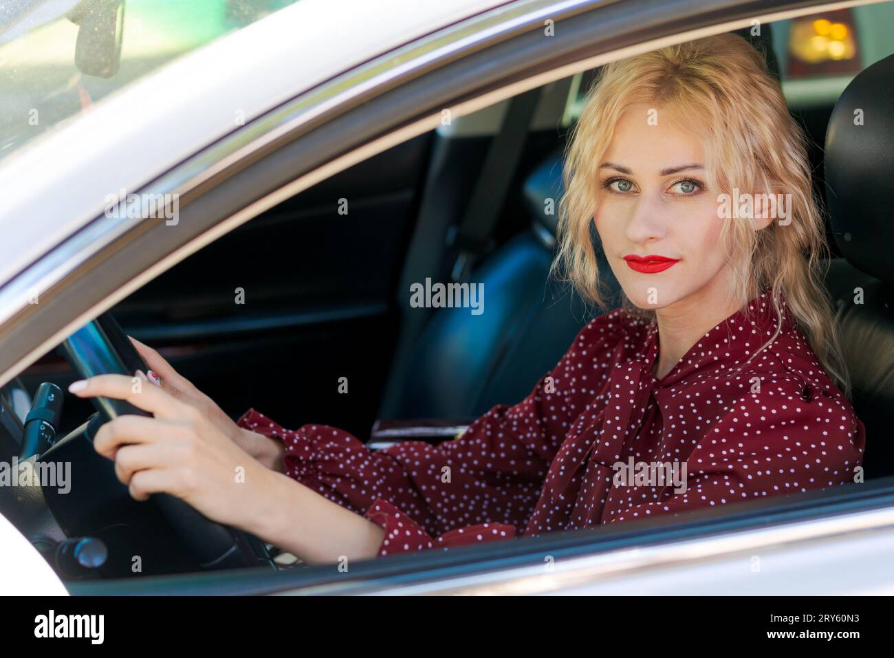 Woman sitting behind steering wheel hi-res stock photography and images ...