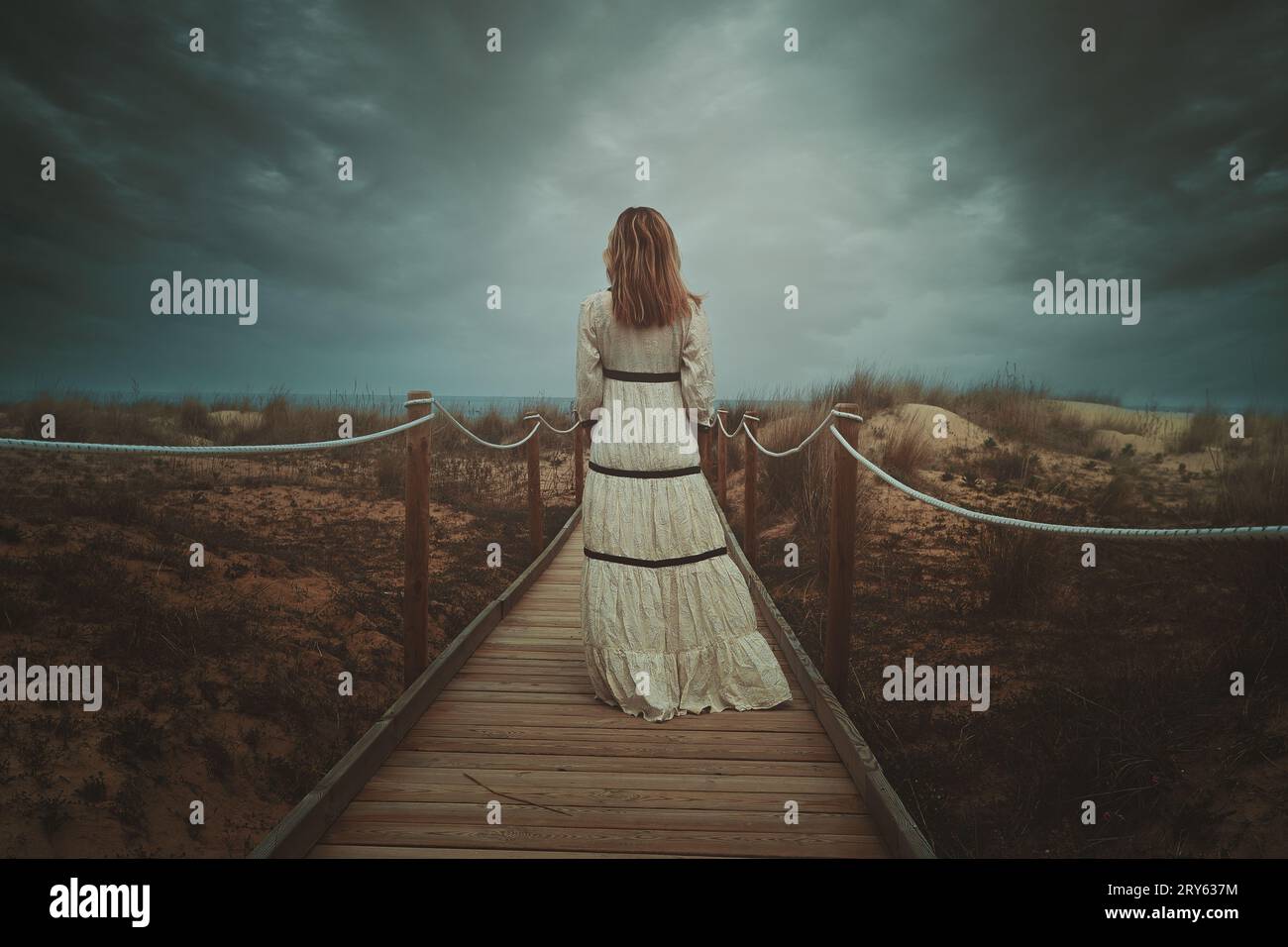 Woman walking beach alone dress hi-res stock photography and images - Alamy