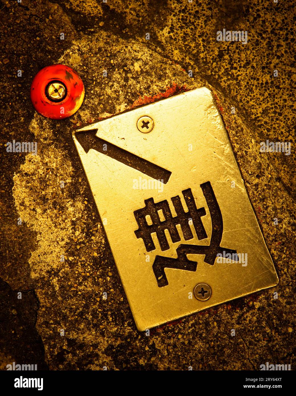 Marker with Japanese characters and arrow on the street, Tokyo, Japan