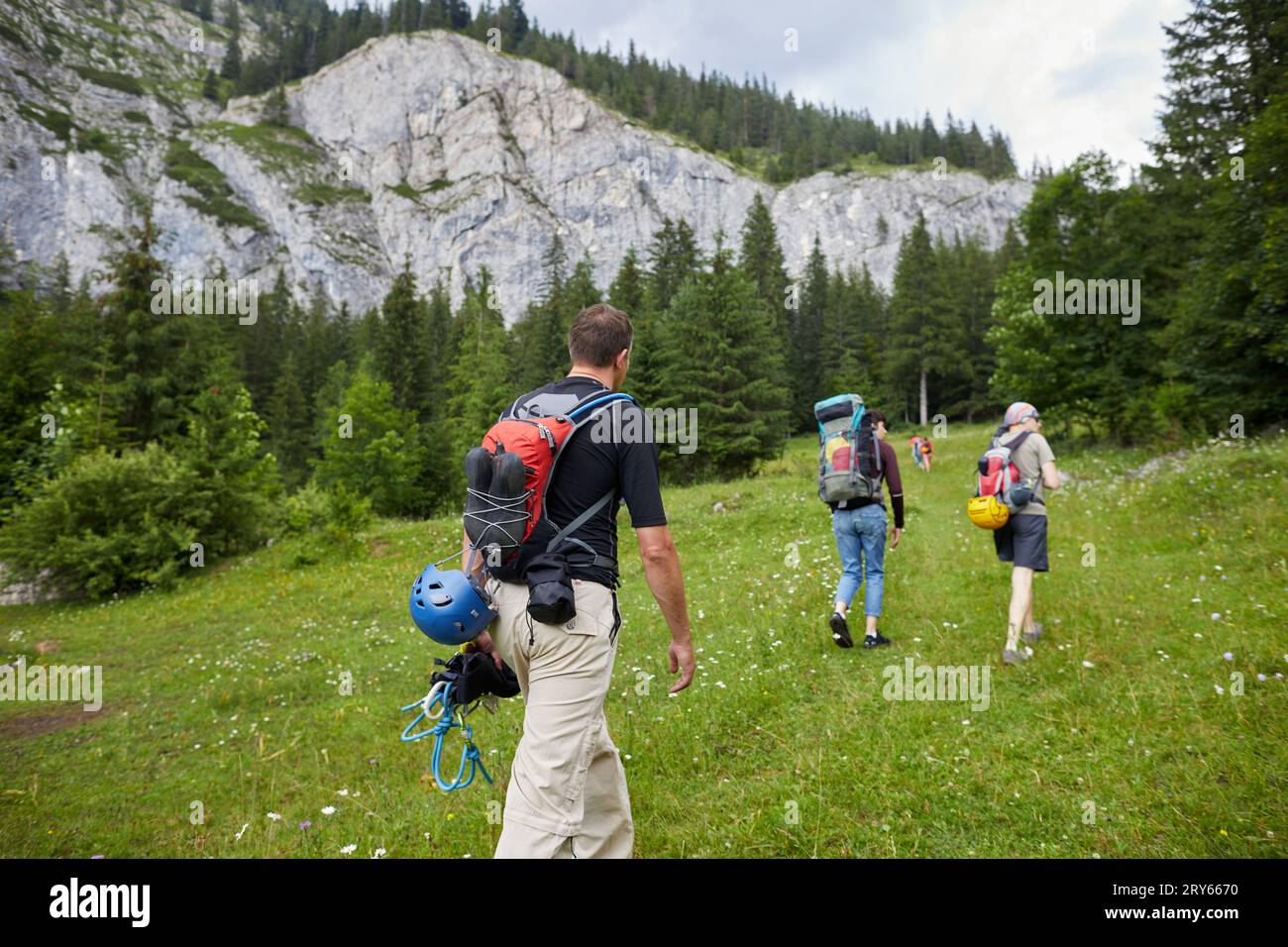 Group of people starting a hike in the mountains Stock Photo